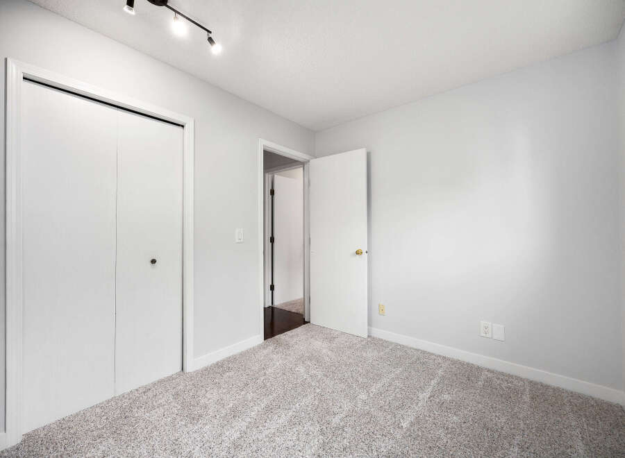 Step into this freshly painted bedroom, featuring plush carpeting and ample closet space.