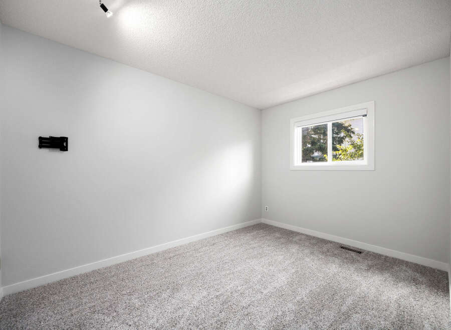 This empty room features a neutral color palette, making it a versatile space ready for your personal touch.