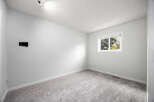This empty room features a neutral color palette, making it a versatile space ready for your personal touch.