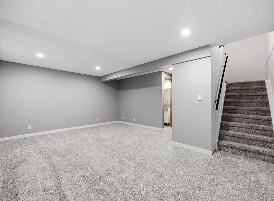 Discover this beautifully finished basement, featuring plush grey carpeting throughout the spacious living area.