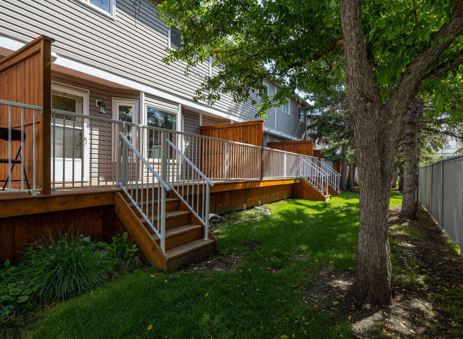 Enjoy outdoor living on this spacious wooden deck, perfect for entertaining or relaxing.