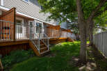 Enjoy outdoor living on this spacious wooden deck, perfect for entertaining or relaxing.
