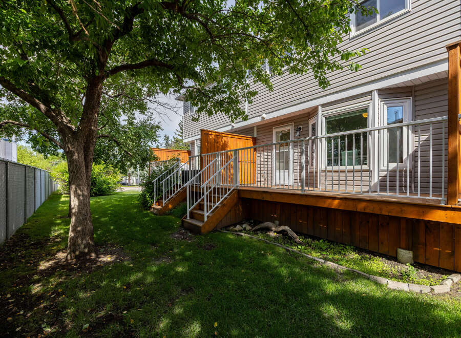 Enjoy outdoor living on this spacious wooden deck, perfect for entertaining or relaxing.
