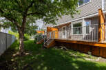 Enjoy outdoor living on this spacious wooden deck, perfect for entertaining or relaxing.