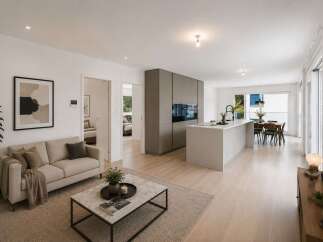 Experience modern living in this open-concept home, featuring a sleek grey kitchen with integrated appliances and a spacious island perfect for entertaining.