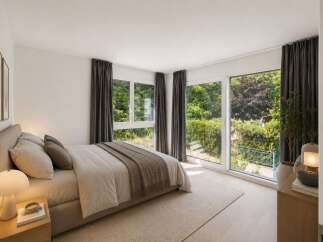 Experience serene living in this beautifully appointed bedroom, featuring a plush bed and soft, neutral linens.