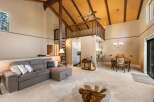 Experience the charm of this inviting living space, featuring a spacious sectional sofa perfect for relaxation and a cozy dining area for intimate meals.