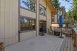 Enjoy outdoor living on this spacious deck, perfect for entertaining or relaxing amidst the trees.