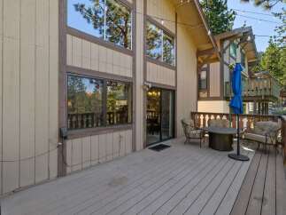 Enjoy outdoor living on this spacious deck, perfect for entertaining or relaxing amidst the trees.