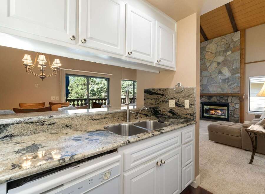 Experience the perfect blend of comfort and style in this inviting living space, featuring a stunning stone fireplace as the focal point.