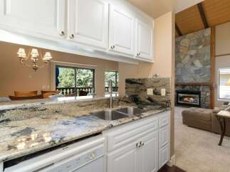 Experience the perfect blend of comfort and style in this inviting living space, featuring a stunning stone fireplace as the focal point.