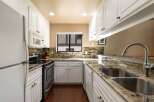 Discover this charming kitchen featuring pristine white cabinetry and elegant granite countertops.