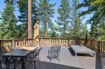 Enjoy breathtaking views from this expansive wooden deck, perfect for outdoor entertaining or quiet relaxation.