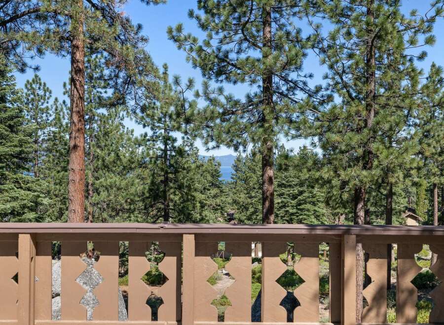 Enjoy breathtaking lake views framed by mature pine trees from this stunning property.