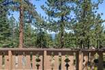 Enjoy breathtaking lake views framed by mature pine trees from this stunning property.