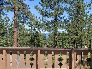 Enjoy breathtaking lake views framed by mature pine trees from this stunning property.