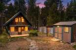 Nestled amidst tall pine trees, this charming rustic cabin offers a serene mountain retreat.