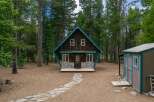 Escape to this charming A-frame cabin nestled amongst tall pine trees, offering a serene mountain retreat.