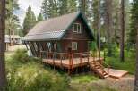 Nestled amongst tall pine trees, this charming cabin offers a serene mountain retreat.