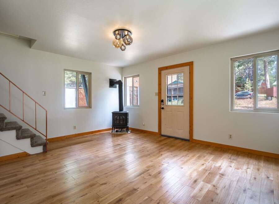 Step into this charming living space featuring a cozy wood-burning stove, perfect for chilly evenings.