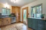 Discover this charming kitchen featuring light wood cabinetry and a sleek stainless steel dishwasher.