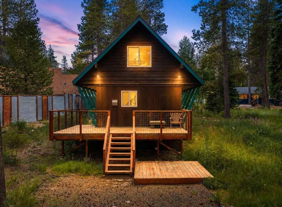 Experience the charm of this rustic cabin nestled among tall pine trees, perfect for a serene getaway.