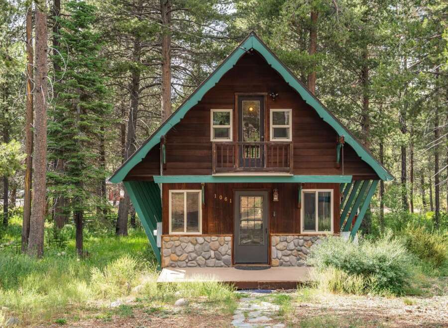 Nestled amidst tall pine trees, this charming cabin offers a serene mountain retreat.
