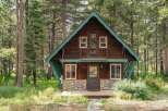 Nestled amidst tall pine trees, this charming cabin offers a serene mountain retreat.
