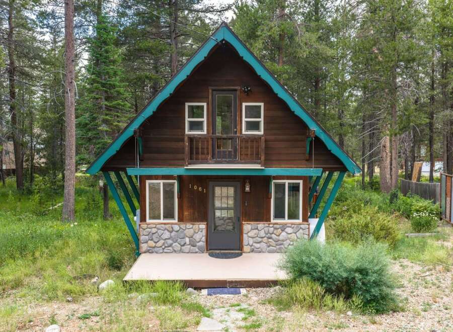 Charming A-frame cabin nestled in a serene forest setting, perfect for a mountain getaway.