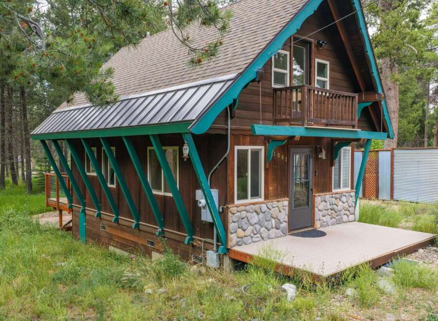 Discover this charming rustic cabin nestled amongst tall pine trees, offering a serene mountain getaway.