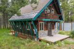 Discover this charming rustic cabin nestled amongst tall pine trees, offering a serene mountain getaway.