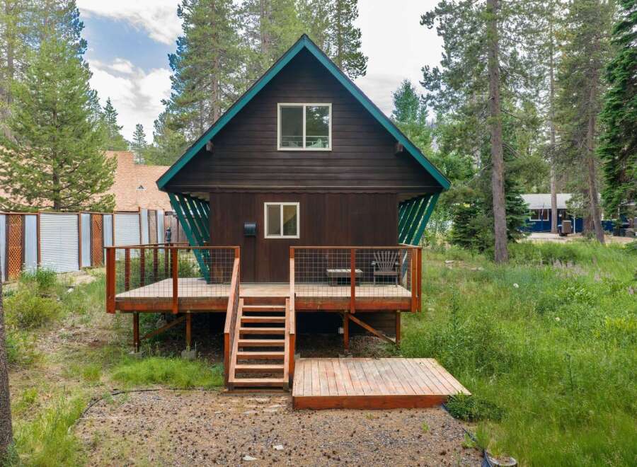 Escape to this charming cabin nestled among tall pine trees, offering a serene mountain getaway.