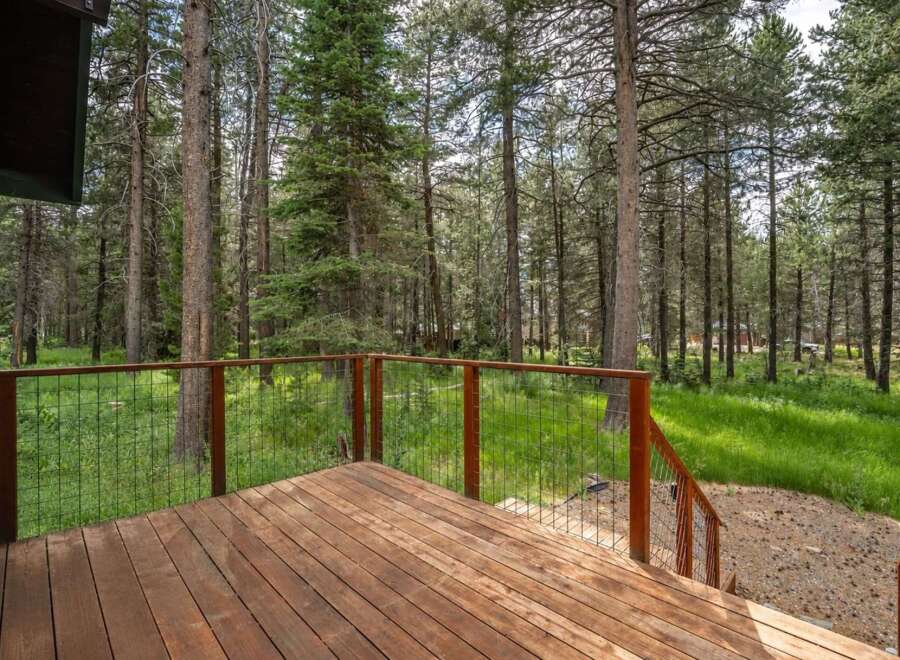 Enjoy the serene mountain lifestyle from this expansive wooden deck, perfect for outdoor living and entertaining.