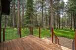 Enjoy the serene mountain lifestyle from this expansive wooden deck, perfect for outdoor living and entertaining.