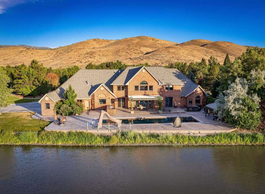 Experience luxury living with this stunning brick estate, featuring a sparkling swimming pool and hot tub perfect for relaxation and entertainment.