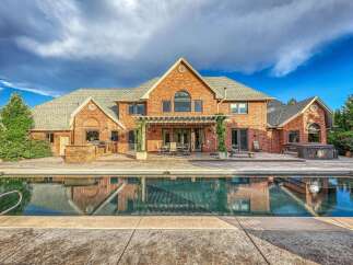Experience luxury outdoor living with this stunning backyard featuring a sparkling swimming pool and a relaxing hot tub.