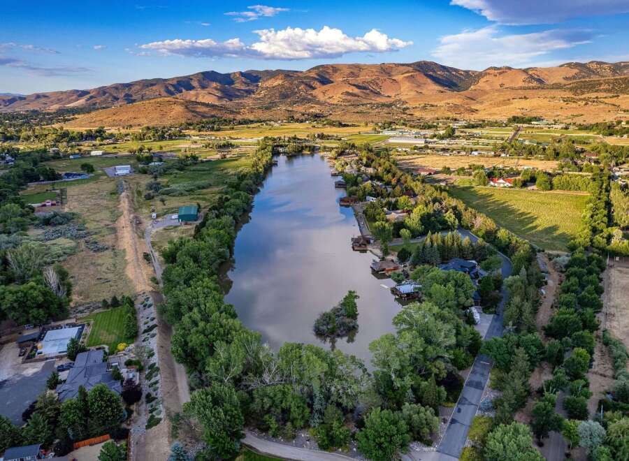 Experience serene waterfront living with this stunning aerial view of a tranquil lake, perfect for water activities and relaxation.
