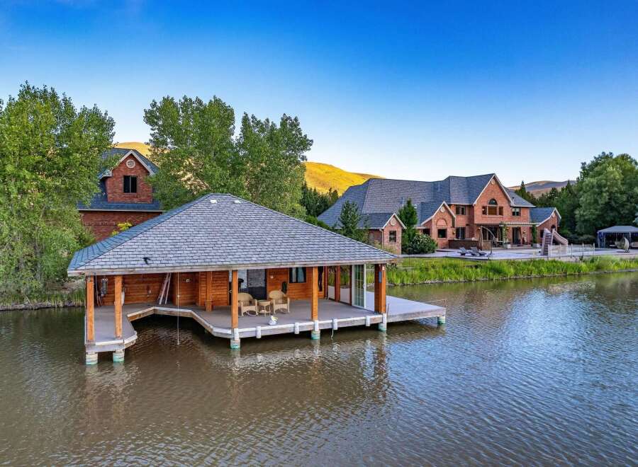 Experience luxury living with this stunning waterfront property, featuring a private boathouse and expansive lake views.