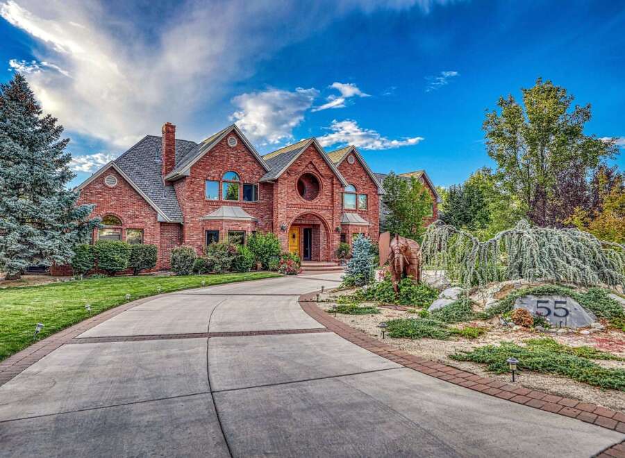 Discover this stunning brick estate, featuring a grand circular entryway and elegant arched windows.
