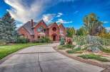 Discover this stunning brick estate, featuring a grand circular entryway and elegant arched windows.