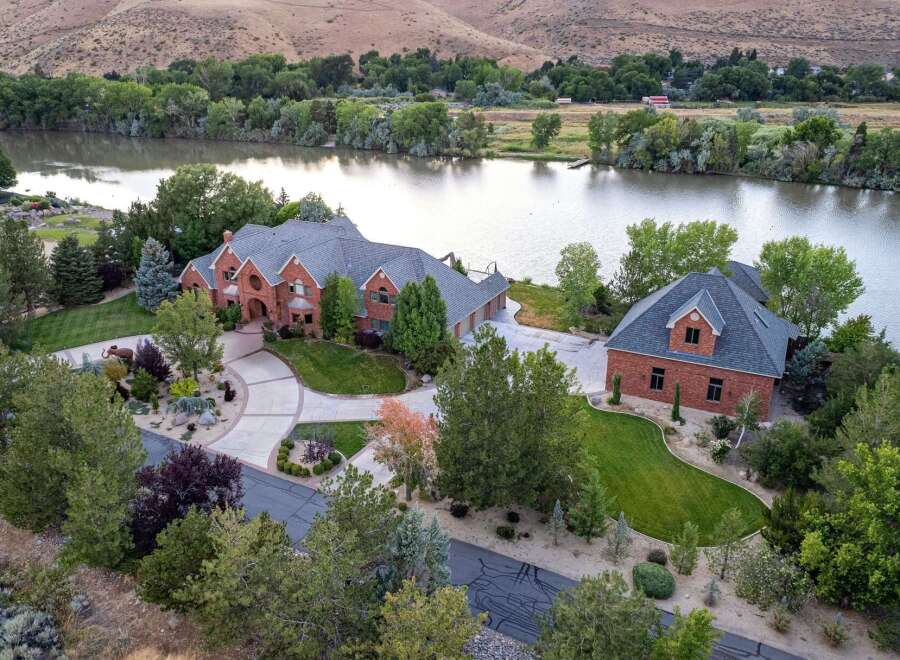 Experience luxury living with this stunning brick estate situated on a serene waterfront.