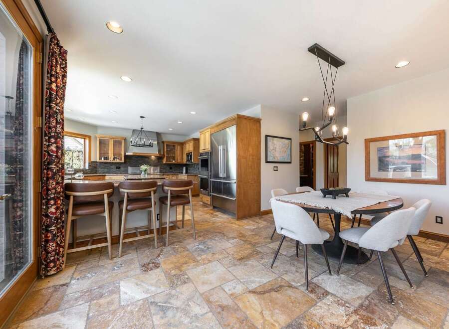 Experience the perfect blend of style and functionality in this spacious kitchen and dining area.