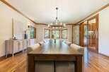 Experience elegant dining in this spacious room, featuring a long, rustic wooden table perfect for gatherings.