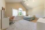 Discover this charming bedroom featuring a comfortable bed with a light green checkered comforter, perfect for a restful night's sleep.