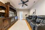 Experience ultimate relaxation in this home theater, featuring plush black leather recliners with built-in cup holders.