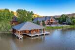 Experience luxury living with this stunning waterfront estate featuring a boathouse and a magnificent brick mansion.