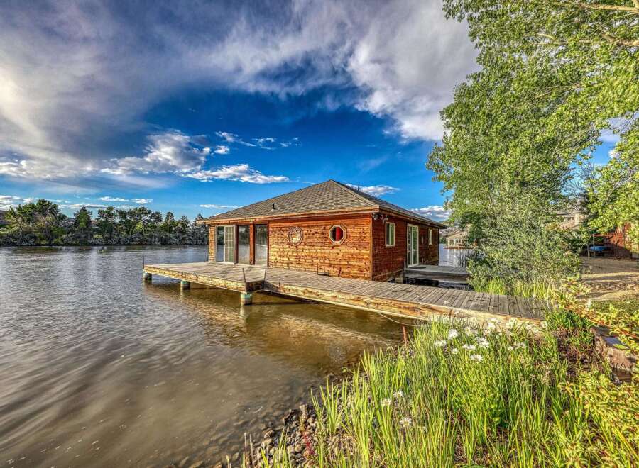 Experience unique waterfront living in this charming wooden boathouse, perfectly situated on the water's edge.