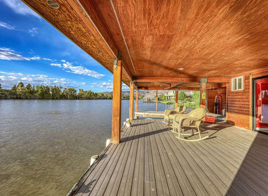 Enjoy breathtaking waterfront living from this stunning covered deck, perfect for relaxing and entertaining.
