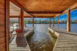 Enjoy waterfront living with this stunning property featuring a private dock and covered boat slip.