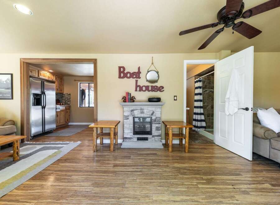 Step into this charming living space featuring a cozy fireplace and rustic wooden accents.